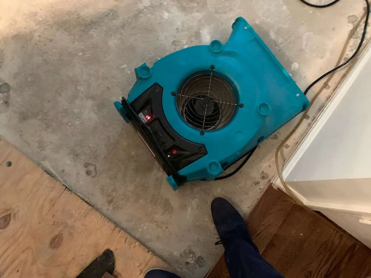 Air mover drying subfloor during Leak Detection & Repair in Laurinburg